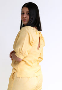 Ruffled top IN-DYAA in light yellow with a cutout in the back - organic cotton